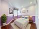 Comfortable bedroom features a cozy bed, wooden floors, and neutral walls at 1772 Garden Sage Dr, Oviedo, FL 32765