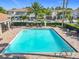 Community pool with paved patio and seating at 1772 Garden Sage Dr, Oviedo, FL 32765