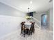 Dining area with white trim, elegant lighting, table for six, and a view of the staircase at 1772 Garden Sage Dr, Oviedo, FL 32765