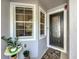 Inviting front entrance with a decorative glass door, sidelight window, and manicured plants at 1772 Garden Sage Dr, Oviedo, FL 32765