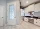 Bright foyer area with custom built-in desk, storage cabinets, and a beautifully decorated front door at 1772 Garden Sage Dr, Oviedo, FL 32765