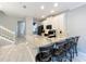 Open kitchen layout with large island, bar seating, and stainless steel appliances and white cabinets at 1772 Garden Sage Dr, Oviedo, FL 32765
