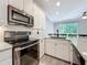 Stylish kitchen featuring stainless steel appliances, white cabinets, and sleek countertops at 1772 Garden Sage Dr, Oviedo, FL 32765