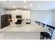 Spacious kitchen island features bar seating and marble countertops with black appliances and white cabinetry at 1772 Garden Sage Dr, Oviedo, FL 32765