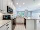 Modern kitchen with stainless steel appliances, white cabinets, and a granite countertop at 1772 Garden Sage Dr, Oviedo, FL 32765