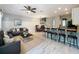 Inviting living area with gray walls, modern furniture, an open floor plan and bar seating at 1772 Garden Sage Dr, Oviedo, FL 32765