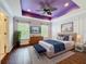This spacious main bedroom features a unique ceiling, a ceiling fan, and lots of natural light at 1772 Garden Sage Dr, Oviedo, FL 32765