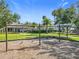 Community playground featuring swings and covered play area amidst lush landscaping and community building at 1772 Garden Sage Dr, Oviedo, FL 32765