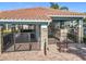 Pool cabana entrance with stone pillars and black metal gate at 1772 Garden Sage Dr, Oviedo, FL 32765