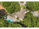Back aerial showing the pool and tropical foliage of the home's outdoor living space at 2105 Fosgate Dr, Winter Park, FL 32789