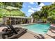 Inviting backyard pool with lounge chairs, and covered patio at 2105 Fosgate Dr, Winter Park, FL 32789