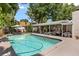 Lovely backyard pool with covered patio, outdoor bar, and tropical landscaping at 2105 Fosgate Dr, Winter Park, FL 32789