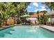 Tranquil backyard pool area surrounded by tropical landscaping and privacy fence at 2105 Fosgate Dr, Winter Park, FL 32789