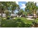Expansive backyard with lush green lawn, mature trees, and inviting pool area at 2105 Fosgate Dr, Winter Park, FL 32789