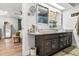 Light filled bathroom featuring double sinks, a granite counter, and neutral decor at 2105 Fosgate Dr, Winter Park, FL 32789