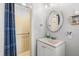 Cozy bathroom featuring a shower with yellow tile, a single sink, and an oval mirror at 2105 Fosgate Dr, Winter Park, FL 32789