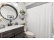 Bathroom featuring a modern vanity, round mirror, and shower at 2105 Fosgate Dr, Winter Park, FL 32789