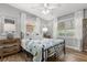 Cozy bedroom features a comfortable bed, soft natural light, and hardwood floors at 2105 Fosgate Dr, Winter Park, FL 32789