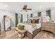 Comfortable bedroom featuring wood floors, ceiling fan, and natural light at 2105 Fosgate Dr, Winter Park, FL 32789