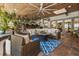 Inviting covered patio with wicker furniture, wood ceilings, ceiling fan, and outdoor bar area for entertaining guests at 2105 Fosgate Dr, Winter Park, FL 32789