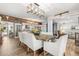 Open-concept dining area with modern light fixture and a view of the kitchen and living spaces, great for entertaining at 2105 Fosgate Dr, Winter Park, FL 32789