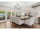 Elegant dining room featuring a wooden table, upholstered chairs, and sliding doors to a beautiful outdoor patio at 2105 Fosgate Dr, Winter Park, FL 32789