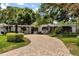 Charming single-story home boasting a brick driveway, neat landscaping, and freshly painted exterior at 2105 Fosgate Dr, Winter Park, FL 32789