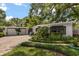 Front exterior of home with well maintained landscaping, brick driveway, and fresh exterior paint at 2105 Fosgate Dr, Winter Park, FL 32789