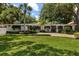 Charming single-story home with well-manicured landscaping, brick driveway, and inviting front entrance at 2105 Fosgate Dr, Winter Park, FL 32789