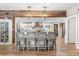 Open kitchen with a large island, stainless steel appliances, custom wood accents, and wood-look tile flooring at 2105 Fosgate Dr, Winter Park, FL 32789