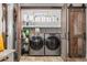Functional laundry room with stainless steel washer and dryer, wooden countertops, and decorative storage baskets at 2105 Fosgate Dr, Winter Park, FL 32789
