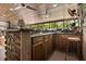 Outdoor kitchen with wood cabinets, stone accents, and a bar for casual dining at 2105 Fosgate Dr, Winter Park, FL 32789