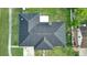 Aerial rooftop view of home featuring a dark gray roof, stone chimney, and fenced in yard at 211 Marion Oaks Ln, Ocala, FL 34473