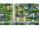 Aerial view of the neighborhood and subject home on a tree lined street on a sunny day at 211 Marion Oaks Ln, Ocala, FL 34473