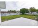 Spacious backyard featuring a concrete patio, a well-maintained lawn, and a traditional wooden fence at 211 Marion Oaks Ln, Ocala, FL 34473