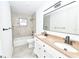 Bathroom with double sinks, granite countertops, shower-over-tub and stylish fixtures at 211 Marion Oaks Ln, Ocala, FL 34473