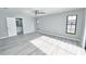Bedroom with gray walls, gray wood flooring, and two windows for natural light at 211 Marion Oaks Ln, Ocala, FL 34473