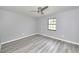 Bright bedroom with a ceiling fan, gray walls and wood-look flooring at 211 Marion Oaks Ln, Ocala, FL 34473