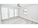 Bedroom featuring a closet with folding doors, gray walls, and wood-look flooring at 211 Marion Oaks Ln, Ocala, FL 34473