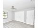 Bedroom featuring closet with folding doors, light gray walls, and wood-look floors at 211 Marion Oaks Ln, Ocala, FL 34473