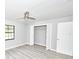 Bedroom featuring a ceiling fan, closet with folding doors, and light gray walls at 211 Marion Oaks Ln, Ocala, FL 34473