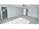 Bedroom with gray walls, gray wood flooring, and access to an en suite bathroom at 211 Marion Oaks Ln, Ocala, FL 34473
