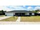 Charming single-story home with a well-maintained lawn and attached garage at 211 Marion Oaks Ln, Ocala, FL 34473