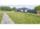 A single-story home with a spacious lawn and modern fence, providing a serene and private outdoor space at 211 Marion Oaks Ln, Ocala, FL 34473