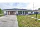 Attractive single-story home with well-maintained lawn and charming exterior details, including black trim and stone accents at 211 Marion Oaks Ln, Ocala, FL 34473