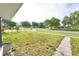 Expansive front yard with a sidewalk and lush green grass leading to a charming neighborhood street at 211 Marion Oaks Ln, Ocala, FL 34473