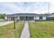 Charming single-story home featuring a landscaped front yard and a welcoming entrance with decorative stone accents at 211 Marion Oaks Ln, Ocala, FL 34473