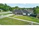 Charming single story home featuring a manicured lawn, dark roof, and a stone accent wall at 211 Marion Oaks Ln, Ocala, FL 34473