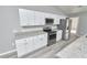 Kitchen featuring modern white cabinets, stainless steel appliances, and granite countertops at 211 Marion Oaks Ln, Ocala, FL 34473