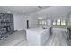 Spacious kitchen with a gray island, stainless steel appliances, and a stone fireplace at 211 Marion Oaks Ln, Ocala, FL 34473